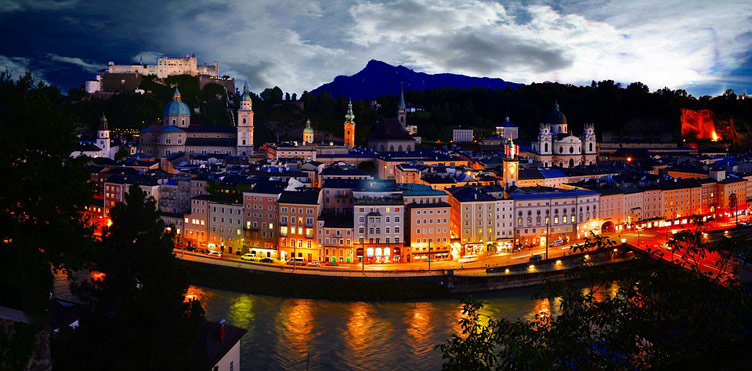 Salzburg old town on the riverfront photographed from above at dusk. 