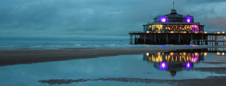 Pictured is the 350 metre long pedestrian pier of Blankenberge built into the sea. The unique structure is a perfect place to take a scenic stroll on a nice summer afternoon. Blankenberge is a coastal town and a perfect destination to relax on your holiday in Belgium. 