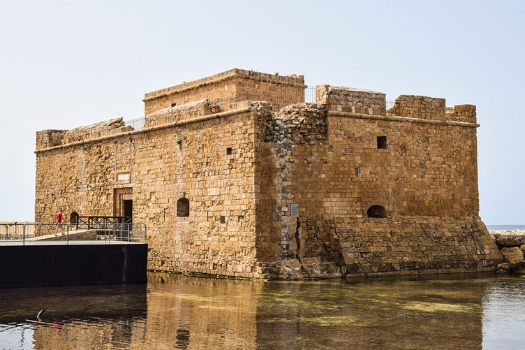 A rectangular block-like castle structure surrounded by water