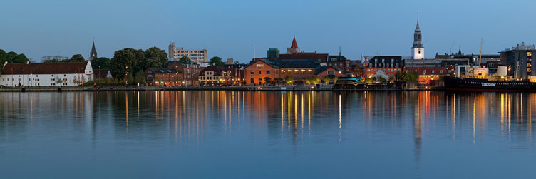 Nightscape of a waterfront city reflected in the body of water