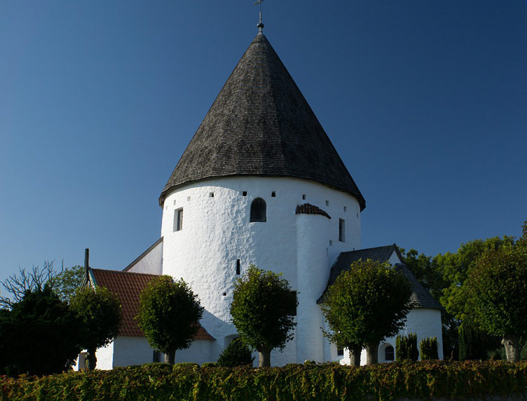 A round white church of Bornhold with a cone shaped roof