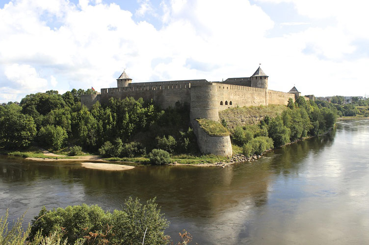 Narva Castle and castle moat full of water in foreground, Estonia