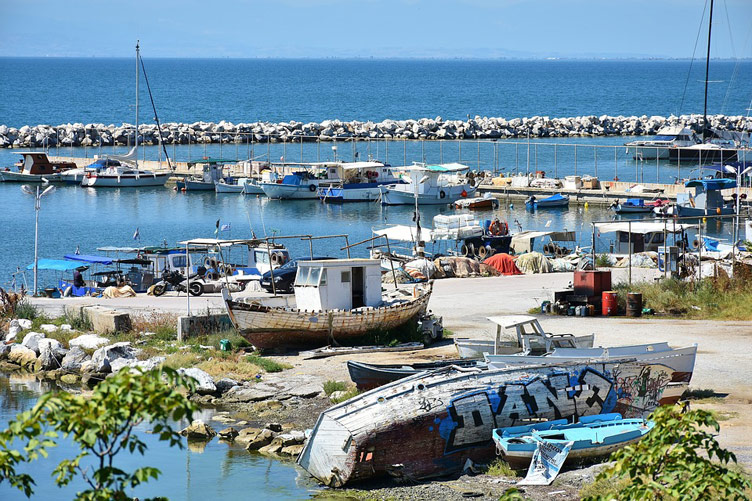 Lots of small boats docked along the coastline