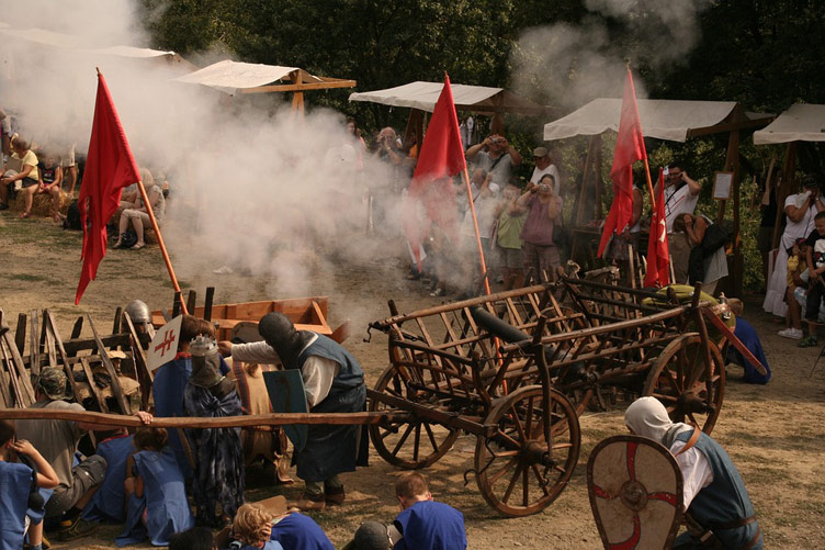 Fancy costume dress castle games with people playing out a castle siege at Holloko castle