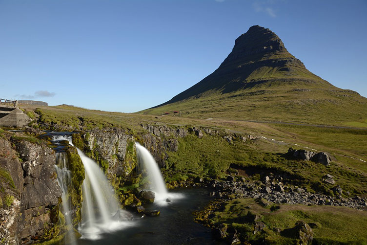 Kirkjufell cone-like mountain with a waterfall at forefront