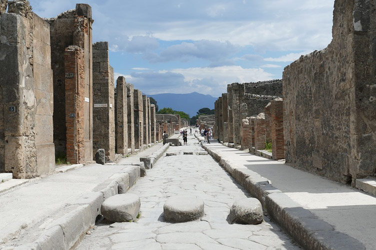 A street in Pompeii with building remains on both sides of the street