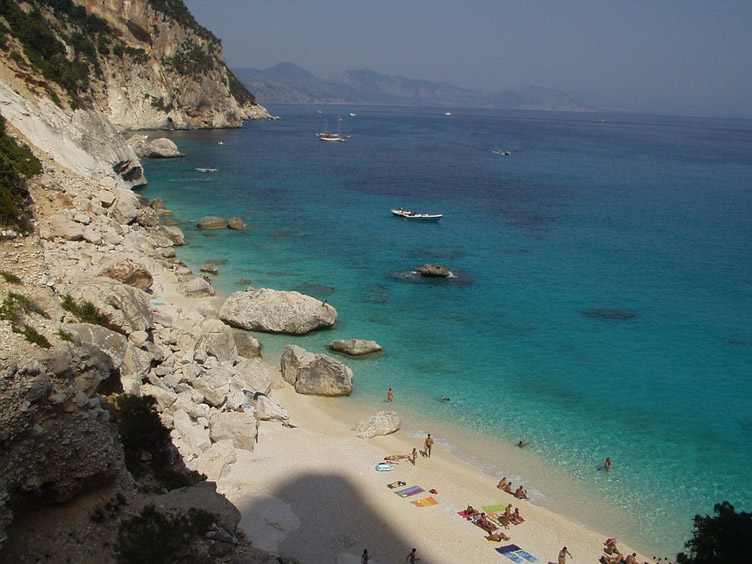 Blue sea, rocks and white sand beach in Sardinia.  width=98%