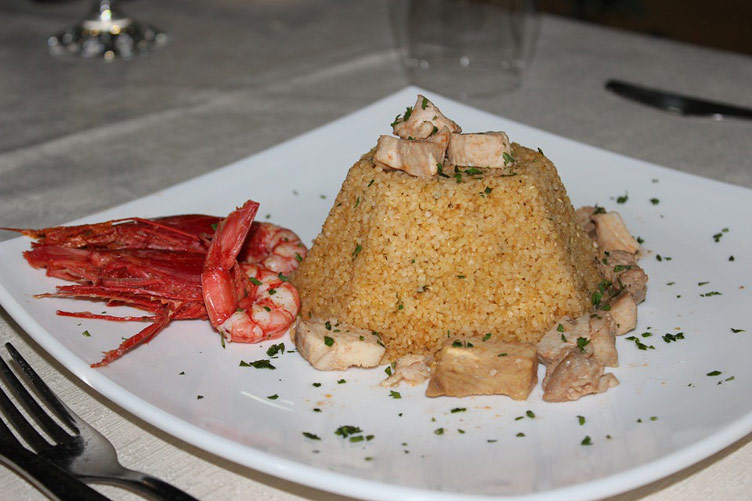 Prawns served next to tasty couscous with herbs. Looks delicious. 