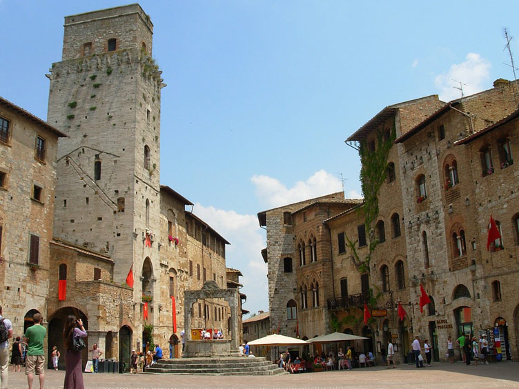 Grand medievil buildings of San Gimignano and a well in town square