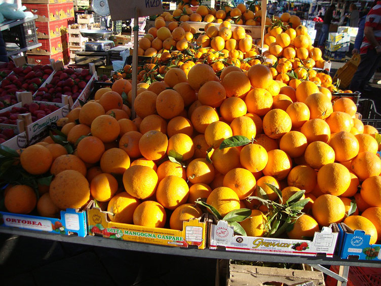 A heap of oranges neatly presented on a market stall in a market in Sicily, Italy. 