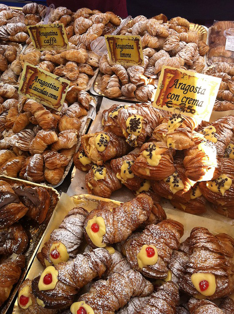 A generous selction of Sicilian pastries and croissants on display in a shop. Looks delicious. 