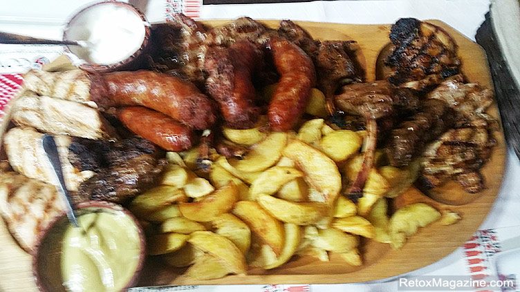 A variety of grilled meats served with chips on a platter