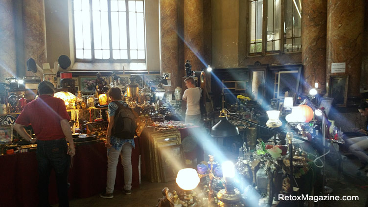 Antiques items displayed by various sellers inside the antique and handmade market