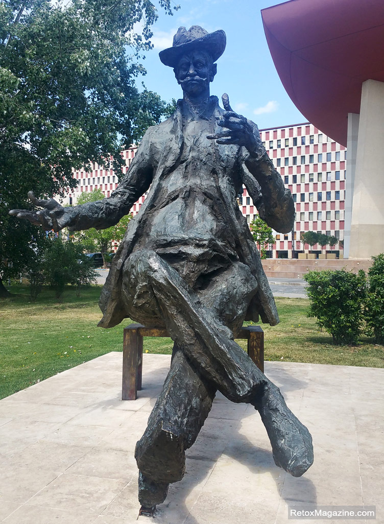 A statue of Ion Luca Caragiale smoking a cigar in front of the National Theatre in Bucharest