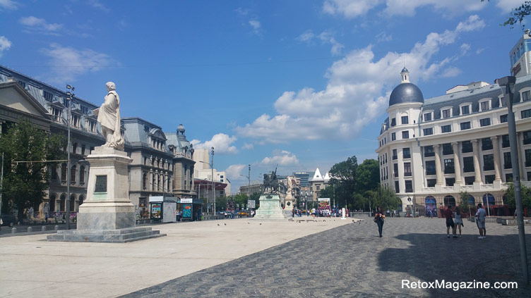 Views of the University Square in Bucharest photographed during the day. The square is home to several statues. Visible to the left is the statue of Ion Heliade Radulescu who was a poet-writer-politician and made significant contributions to the Romanian culture. 