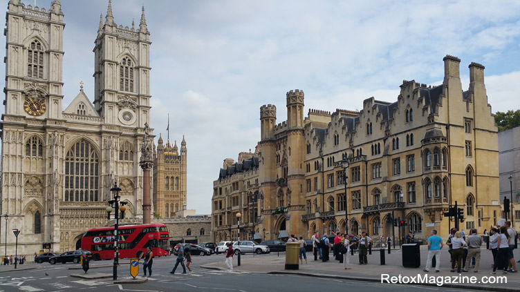 Pictured is a typical double-decker red London bus going past Westminster Abbey